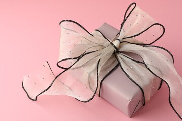 Wall Mural - Gift box with beautiful bow on pink background, closeup