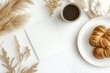 © Odrua Design - Xícara de café elegante com detalhes dourados, acompanhada de doces e decorações festivas em fundo branco, criada com IA generativa para um visual sofisticado e convidativo