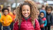 © Юлия Гриб - Smiling Child With Curly Hair Leads a Group of Joyful Kids During an Outdoor Activity in a Park on a Sunny Day