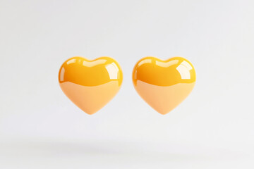 Poster - Dual glossy hearts on a light background symbolize love and connection in vibrant yellow tones
