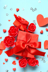 Wall Mural - Gift boxes with red roses and paper hearts on blue background. Valentine's Day celebration