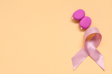 Wall Mural - Female breast made of play dough and pink ribbon on color background. Breast cancer awareness concept