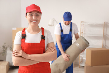 Wall Mural - Loaders with rolled carpet in room