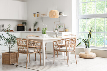 Wall Mural - Interior of light dining room with table and wicker chairs