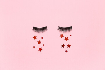 Wall Mural - false eyelashes with sequins on pink background