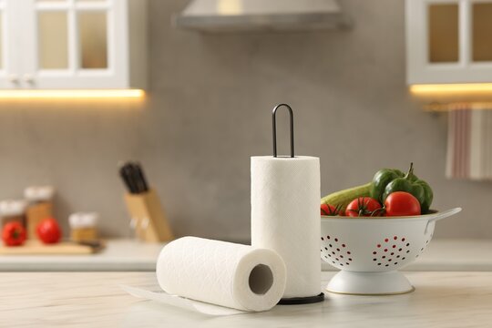 Wall Mural -  - rolls of paper towels and vegetables on white marble table in kitchen