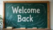 ©  AtlAnt - Welcome back sign written on a chalkboard with books on a wooden shelf in a classroom