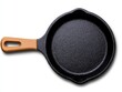 © VANATSANUN - A clean, black cast iron skillet ready for cooking delicious meals. Perfect for any kitchen design.