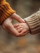 © Vyatcheslav - Mother and baby holding hands, with cozy knitted sweaters and warm, autumnal background