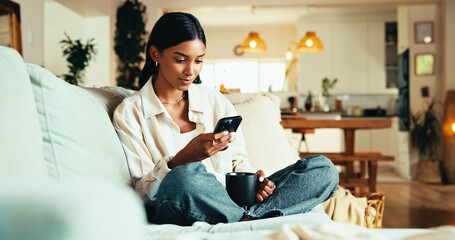 Aufkleber - Woman, mobile and coffee on sofa with social media, reading blog and app subscription in home. Girl, warm beverage and phone in living room for relax, streaming video and green tea benefits research