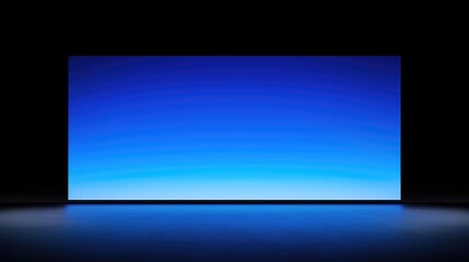 Canvas Print - Wide blue gradient screen in dark room, reflecting on floor.