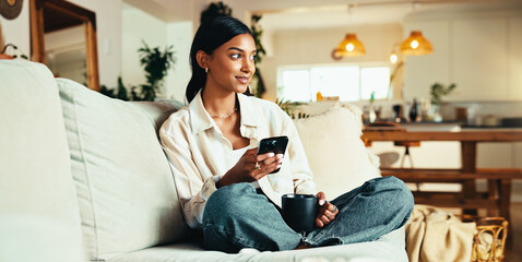 Aufkleber - Woman, thinking and coffee on sofa with phone, social media or app subscription in home. Girl relax, warm beverage or mobile in living room for post comment opinion, streaming service or connectivity