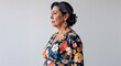 © sevenSkies - Hispanic woman floral print dress middle age side view portrait on plain white background