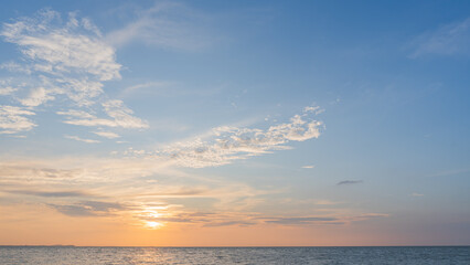 Wall Mural - sunset sky clouds over sea in the evening with orange, yellow sunlight, horizon sea landscape backgr