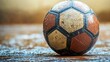 © Id_Stock - Wet, Worn Soccer Ball on the Ground: A Close-Up View of a Classic Game