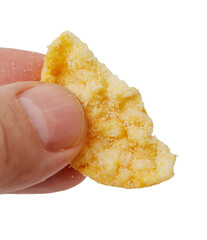 A hand holding a piece of food that is broken in half