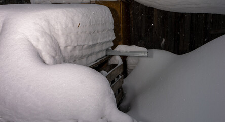 Poster - A wooden crate is covered in snow