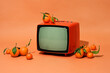 © Cavan Images - Retro orange old television and oranges