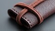 © MAKASIHMAS SIDNEY - Close-up of brown leather case with cord