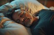 © Prime Look - Calm middle aged man sleeping on bed, on soft pillow under duvet in bedroom interior, enjoying healthy sleep, profile shot, top view, Generative AI