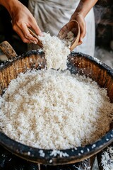 Wall Mural - Close-up of person preparing rice dishes in a wooden bowl, cooking for a restaurant