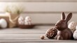 © Y_Malashkevych - A delightful chocolate bunny sits prominently on a rustic table surrounded by decorative eggs. The scene captures the essence of Easter with a warm softened light in the background