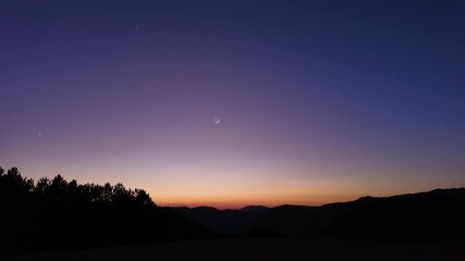 Wall Mural - crescent young moon with stars, planets and countryside silhouettes.
