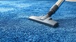 © timurlan999 - Vacuum cleaner is cleaning blue carpet at home