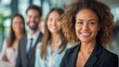 © IMG visuals AI - Confident black businesswoman smiles in focus, with blurred team portrait image. Workplace collaboration diverse picture photorealistic. Organizational culture concept photo realistic