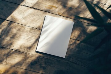 Aufkleber - Blank notebook resting on rustic wooden surface under soft sunlight with shadow patterns