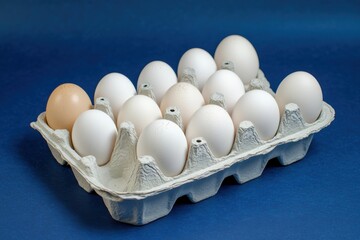Poster - Fresh eggs arranged in a carton on a blue background showcasing their smooth surfaces and varying colors