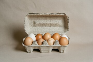 Poster - Fresh eggs displayed in a carton showcasing various colors and sizes in a neutral setting