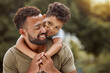 © Jade Maas/peopleimages.com - Family, love and father with son at a park, relax and embrace while enjoying quality time, bonding and fun in nature. Black family, kids and parent hug, smile and enjoy free time and a walk in forest
