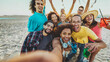 © Davide Angelini - Multiracial friends group taking selfie picture on summer vacation - Young people having fun at festival beach party - Teenagers hanging outside together on a sunny day - Youth and travel concept