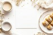 © Odrua Design - Xícara de café elegante com detalhes dourados, acompanhada de doces e decorações festivas em fundo branco, criada com IA generativa para um visual sofisticado e convidativo