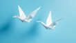 © Anthichada - Two white paper origami bird, Emerging as a symbol of hope, Freedom, Peace and love. Humanity to stop war and spirituality