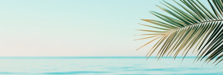 Poster - Tropical palm leaf dominates the foreground, gently swaying against a backdrop of serene turquoise ocean waters under a soft sunrise sky, creating a peaceful and idyllic coastal scene
