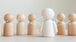 © NanisHappy - A group of wooden figurines, with one central white figure connected to others by fine lines, symbolizing connection and collaboration.
