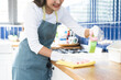 © KMPZZZ - Cleanliness service concept, housekeeping asian young woman working chore cleaning on counter at home, wearing glove using rag rub wiping dirty in kitchen. Housework or chores and clean up, cleaner.