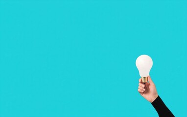 Poster - A creative hand holding a light bulb against a vibrant turquoise background, symbolizing innovation and bright ideas.