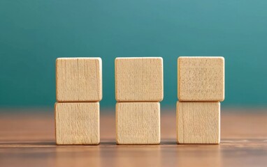 Poster - Three wooden blocks arranged in a playful manner on a wooden surface, ideal for educational and creative projects.