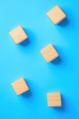 Poster - set of wooden blocks on a vibrant blue background, perfect for educational concepts and playful desi