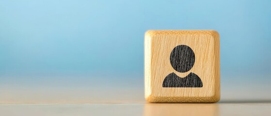 Poster - A close-up of a wooden block featuring a simple person icon, ideal for themes of identity, community, and connection.