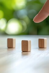Poster - A finger poised above wooden blocks on a table, symbolizing decision-making and strategy in a calm, natural setting.