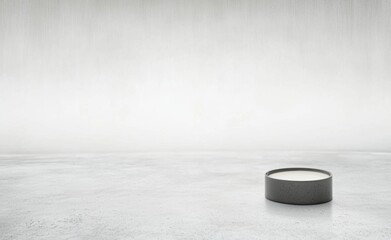 Poster - Single gray concrete candle placed on a white floor with a soft, minimalist background, creating a clean and serene atmosphere
