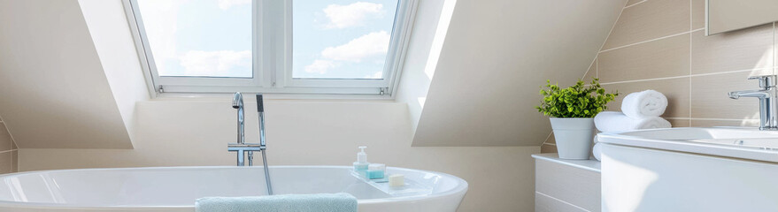 Aufkleber - bright and modern attic bathroom with freestanding bathtub, skylight windows, and beige tiled walls, creating serene and airy atmosphere