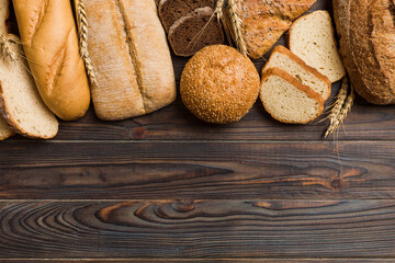 Wall Mural - Homemade natural breads. Different kinds of fresh bread as background, top view with copy space