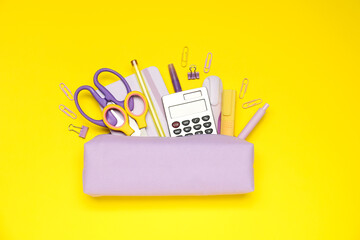 Wall Mural - Pencil case and different stationery on yellow background, flat lay