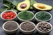 © Ekkarat_Studio - Stylized Arrangement of Various Superfoods Including Goji Berries, Spirulina, Chia Seeds, and Avocado Slices