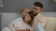 © Krakenimages.com - Couple relaxing in comfortable living room, woman leaning on man, home interior with cozy ambiance, showing love and togetherness